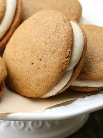 Pumpkin Whoopie pies on a white footed cake dish