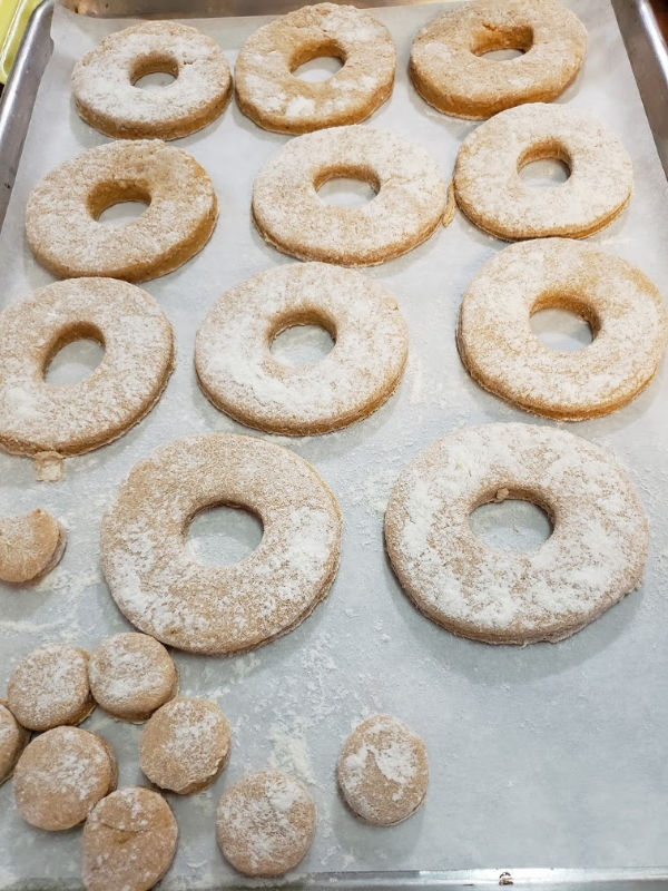 doughnuts on a half sheet pan before frying