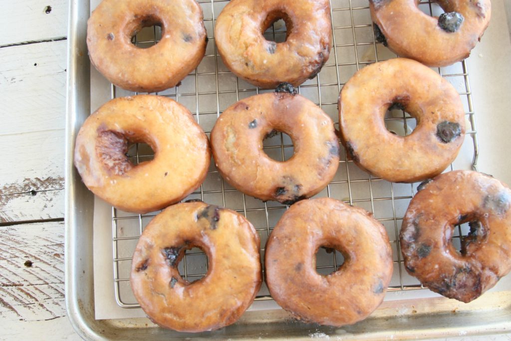 blueberry cake doughnuts glazed drying on baking rack