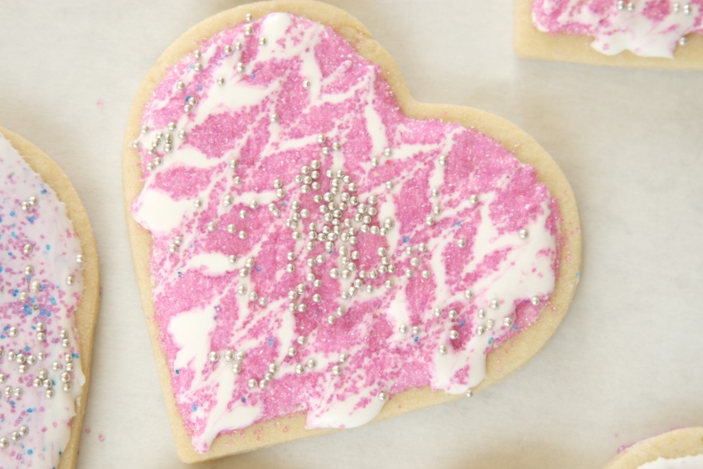 Valentines day cookies wtih pink icing and sprinkles