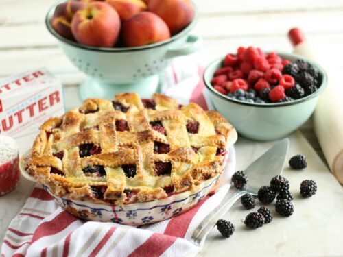 Peach medley pie with weaved crust in a vintage Polish pottery floral pie plate