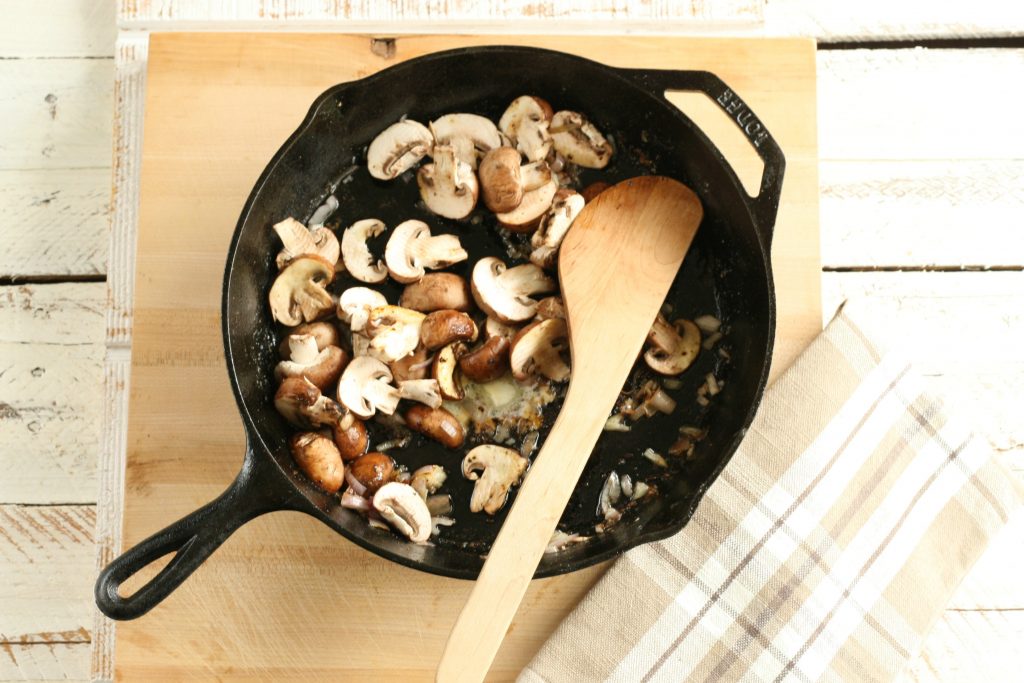 mushrooms browing in a cast iron skillet