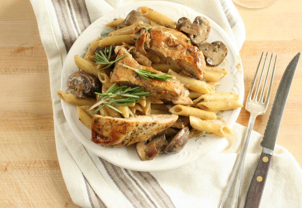 lemon rosemary chicken pasta on white serving plate