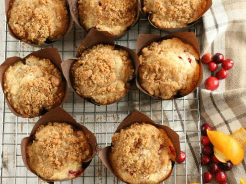 Cranberry Orange muffins with crumb topping in brown tulip style paper cupcake liners