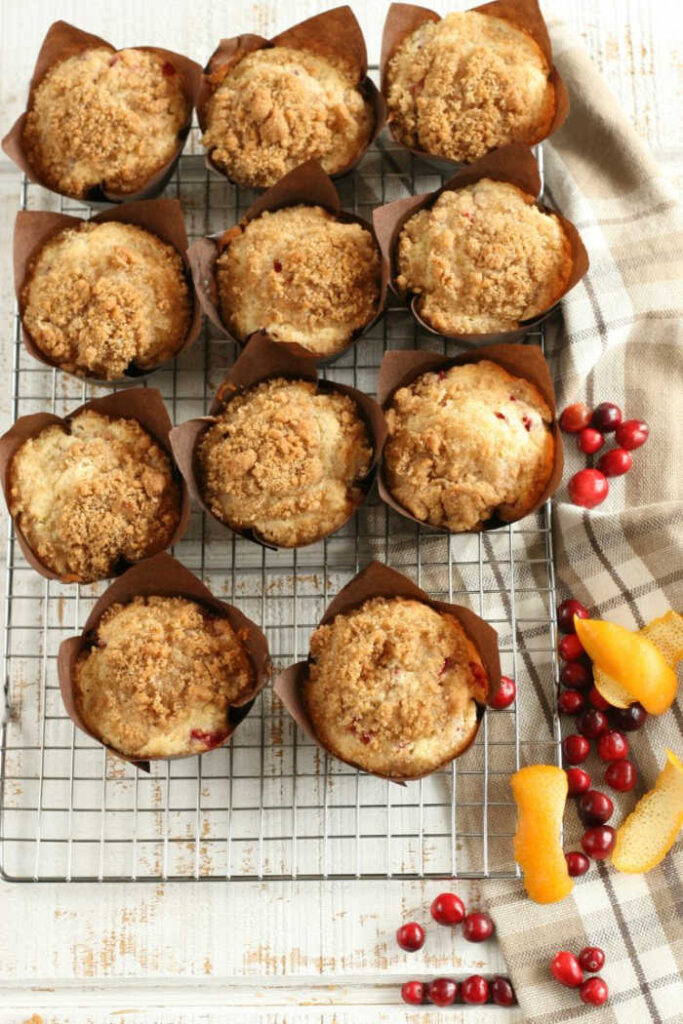 Cranberry Orange muffins with crumb topping in brown tulip style paper cupcake liners