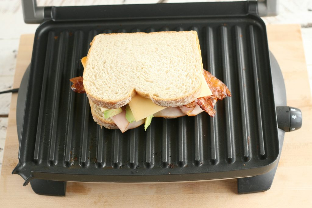 turkey bacon avocado panini on a panini press