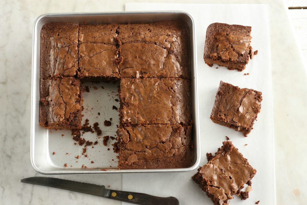 Chewy fudge brownies in a square baking pan cut into squares