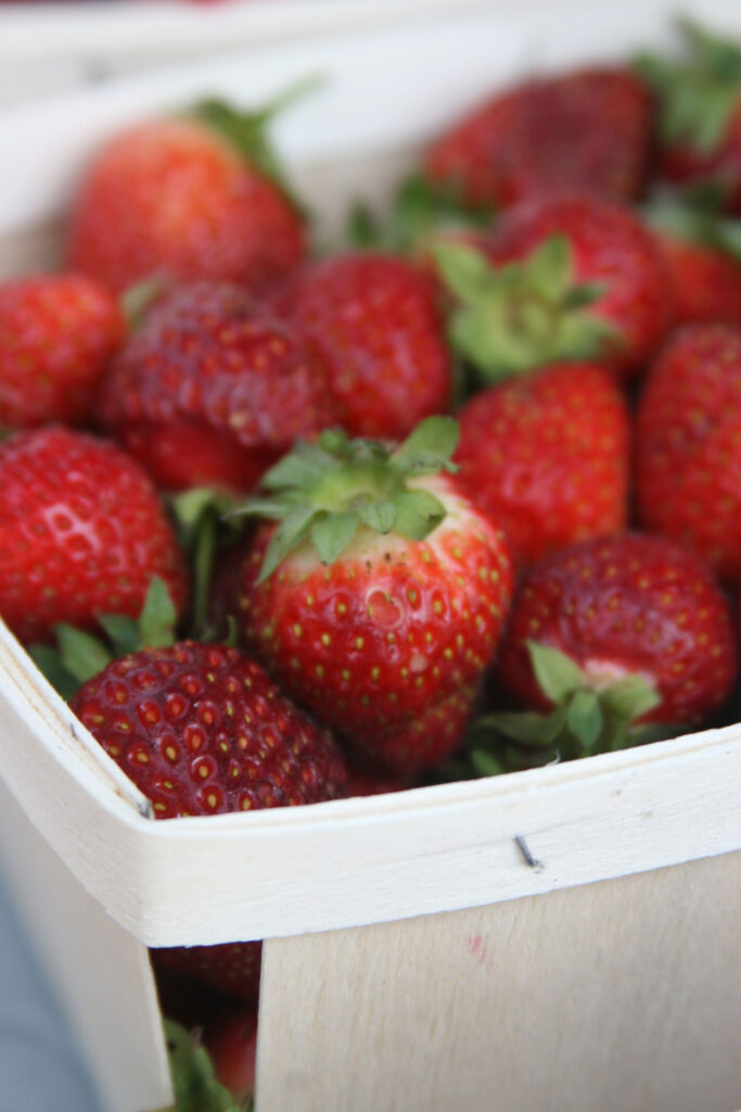 fresh strawberries in a wooden pint market container