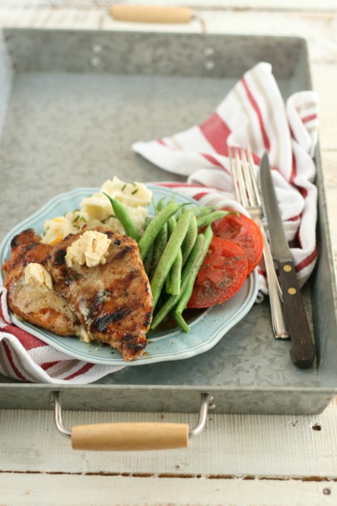 Grilled Maple Balsamic Pork Chops on a light blue plate with seasonal vegetables
