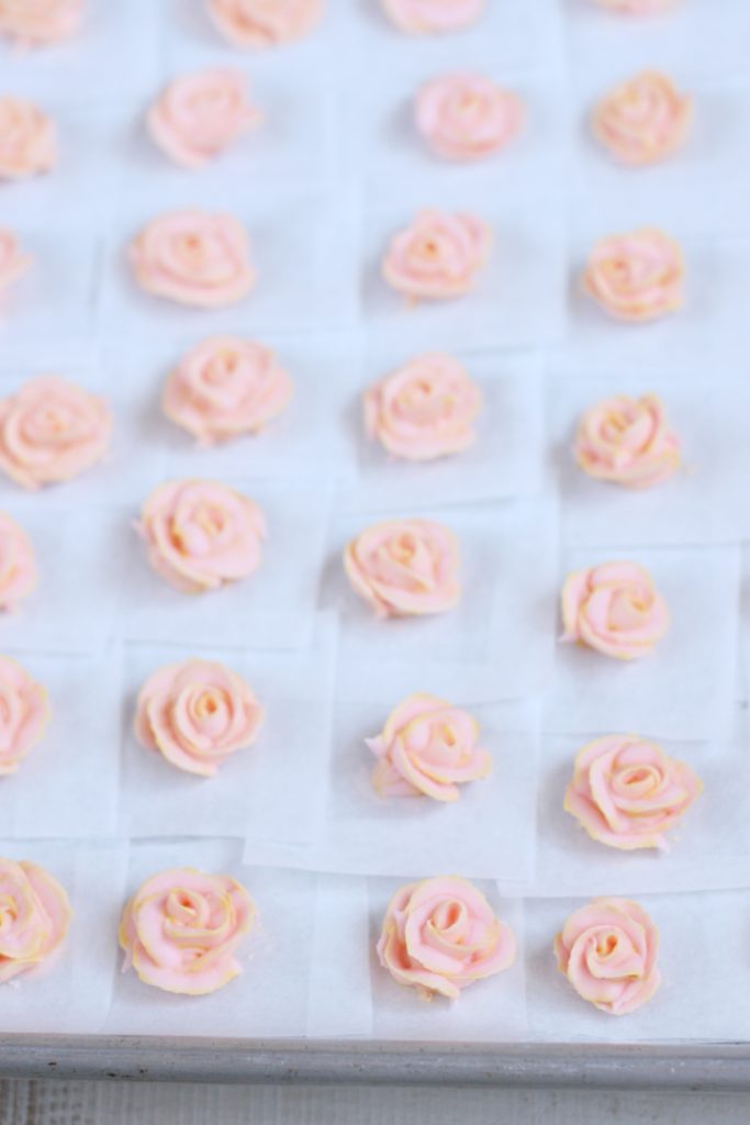 Pale pink royal icing roses on sheet pan