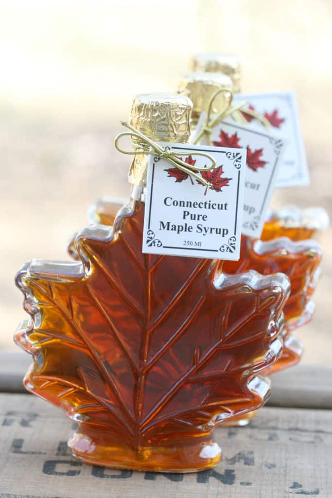 Pure maple syrup in Italian glass maple leaf shaped containers, square paper tag tied on with gold loop