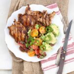 Southwestern grilled chicken thighs with avocado tomato salad