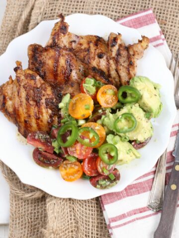 Southwestern grilled chicken thighs with avocado tomato salad