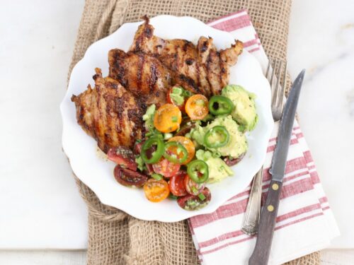 Southwestern grilled chicken thighs with avocado tomato salad