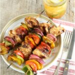 barbecue chicken kebabs with multi-color Bell peppers on plate