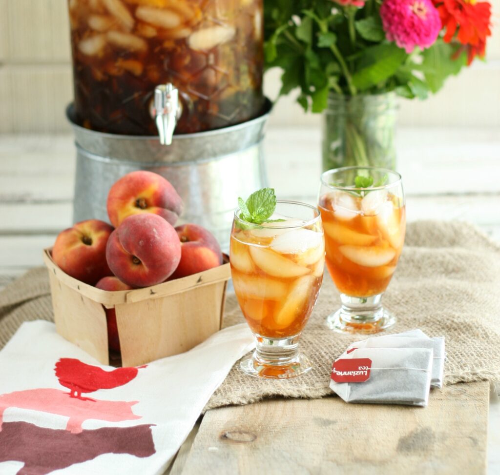 glasses of peach sweet tea with ice cubes and fresh mint.