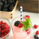 blackberry raspberry lemonade in glass with fresh raspberry and blackberry for garnish
