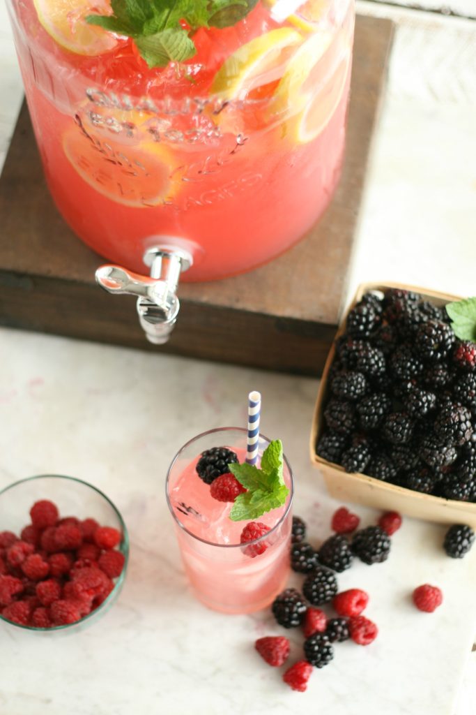 glass drink dispenser and glass of blackberry raspberry lemonade