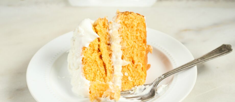 This wonderfully moist Easy Orange Dreamsicle Cake with only a few simple ingredients. Layered with a pineapple and coconut filling. #dreamsiclecake #orangecake #cake #recipes
