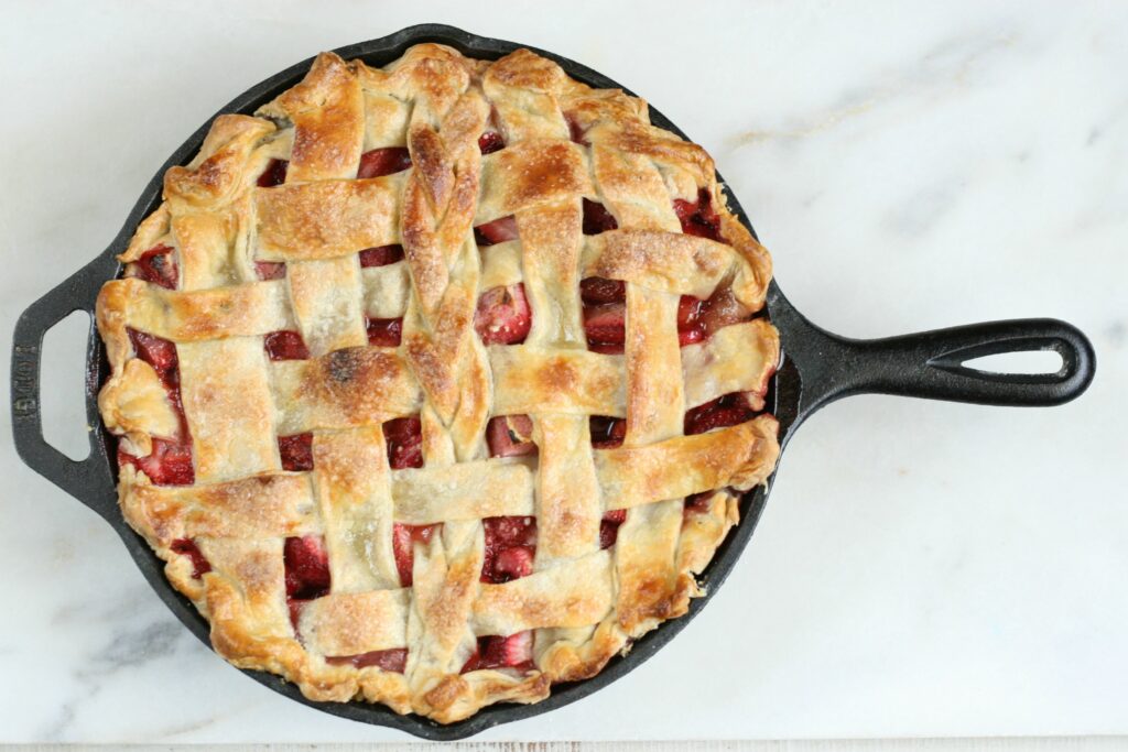 trawberry Rhubarb Pie with lattice crust in a cast iron skillet