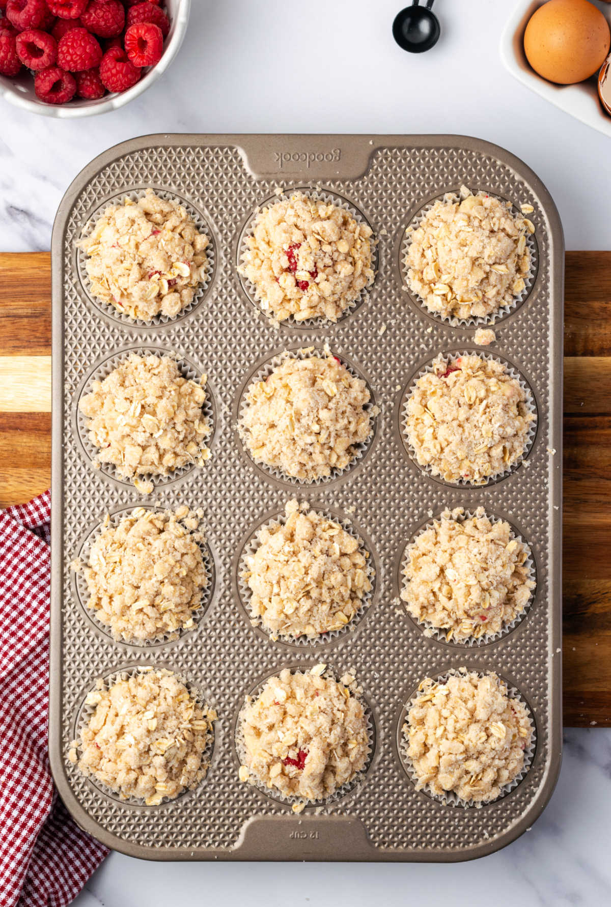 Unbaked muffins in muffin pan.