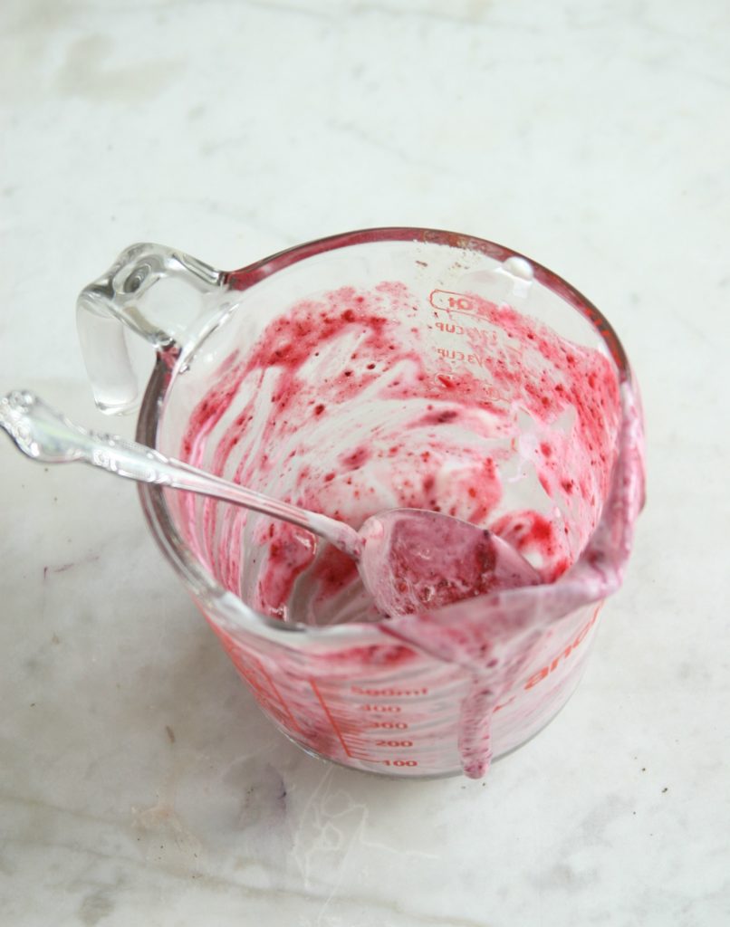 Glass measuring cup with berry swirl yogurt pop puree