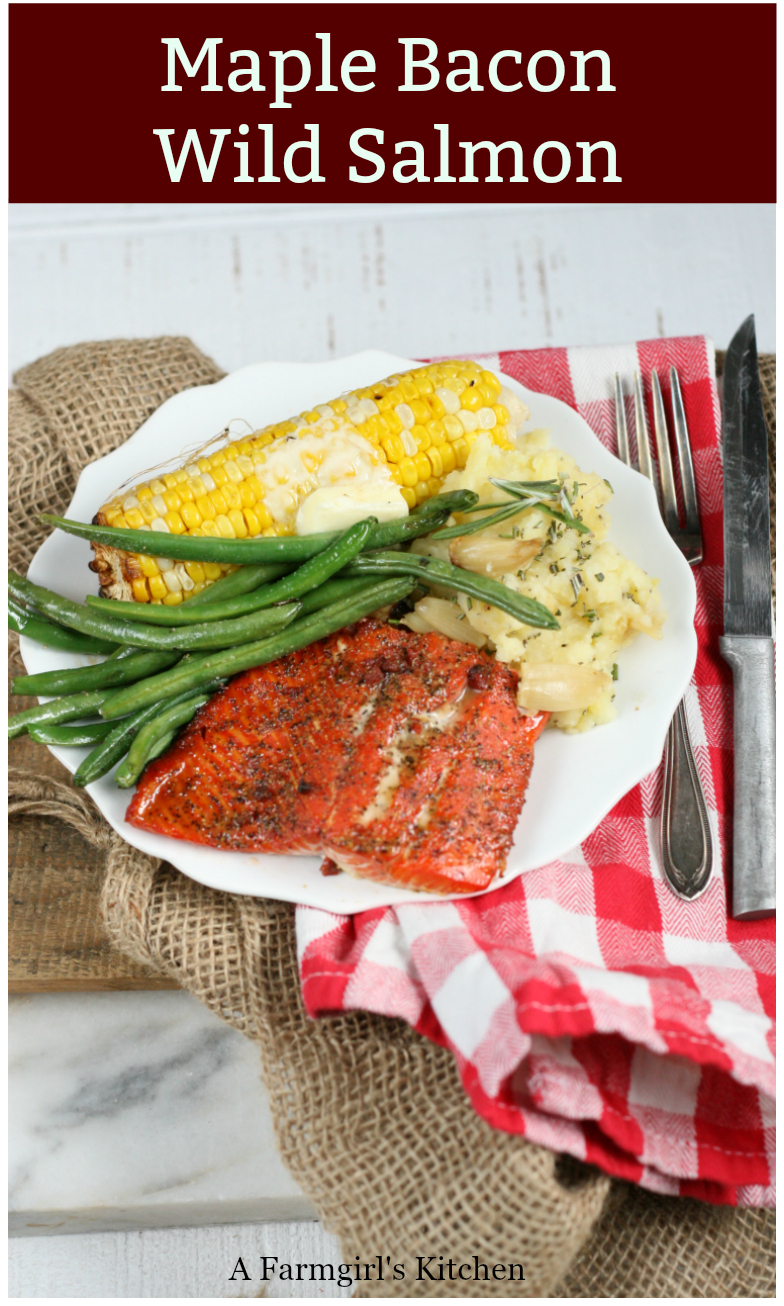Maple Bacon Wild Salmon is grilled over charcoal on a wooden plank, wonderfully moist and flavorful. Get the #recipe #grilling #grilledsalmon #salmon #easyrecipes