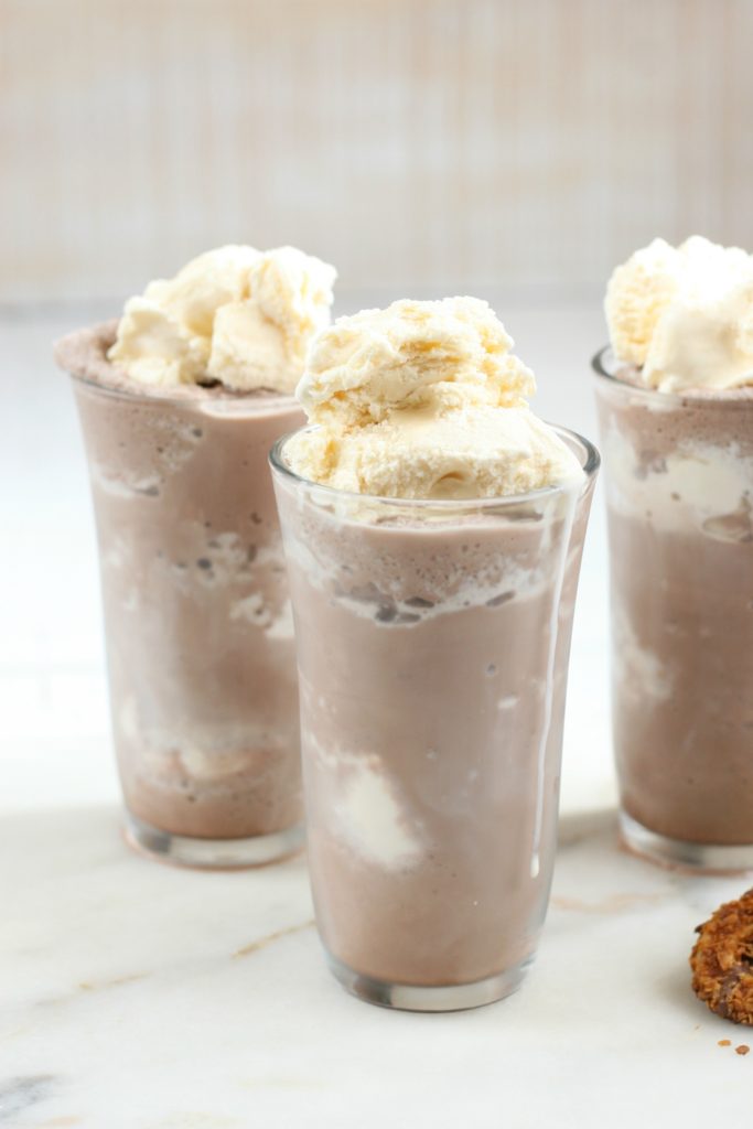 frozen hot chocolate with scoops of vanilla ice cream at top of glasses