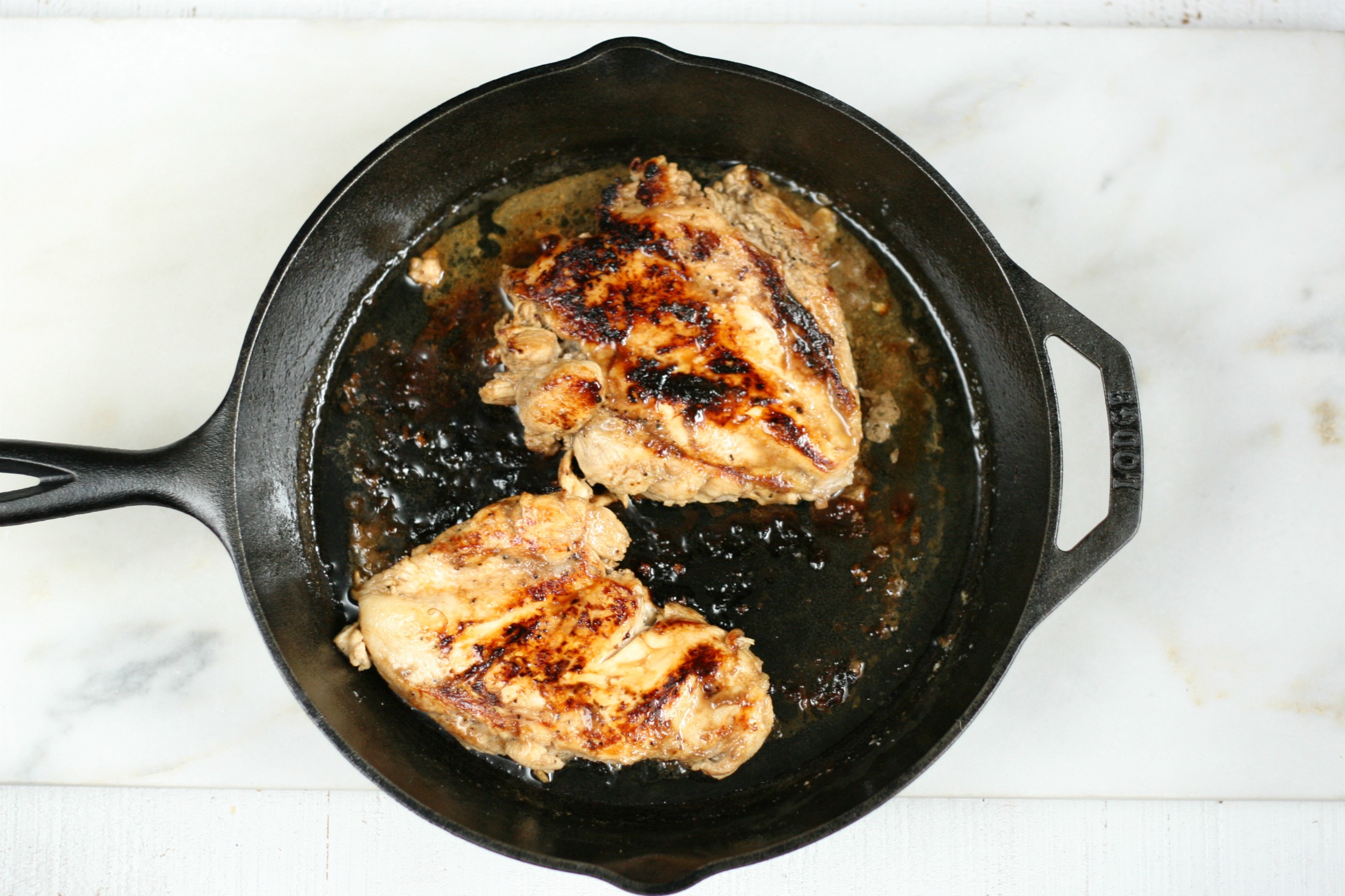 apple cider marinated grilled chicken in a Lodge cast iron skillet.