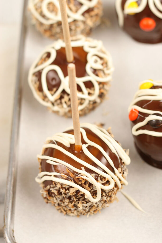 caramel apples dipped in chocolate, drizzled with white chocolate