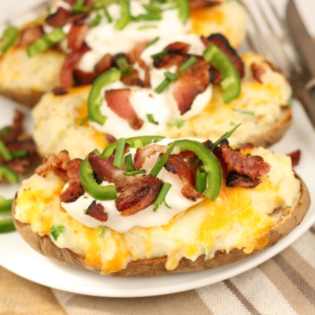 twice baked potatoes with sour cream, bacon, chives, and jalapeno slices