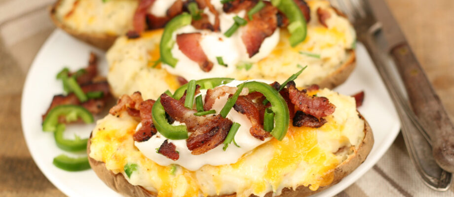 twice baked potatoes with sour cream, bacon, chives, and jalapeno slices