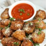 Parmesan Chicken bites with small bowl with marinara sauce