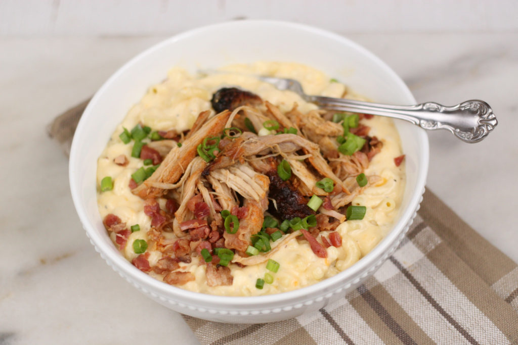 The Best Homemade Mac and Cheese Recipe is super creamy and topped with Applewood Bacon Pulled Pork. This dish uses two different kinds of cheeses in a homemade cheese sauce for the ultimate comfort food!