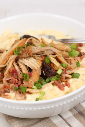 The Best Mac and Cheese Recipe is super creamy and topped with Applewood Bacon Pulled Pork. This dish uses two different kinds of cheeses in a homemade cheese sauce for the ultimate comfort food! #bestmacandcheese #recipes #recipe #kidfriendly #macandcheese #macaroni