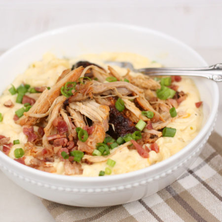 The Best Mac and Cheese Recipe is super creamy and topped with Applewood Bacon Pulled Pork. This dish uses two different kinds of cheeses in a homemade cheese sauce for the ultimate comfort food! #bestmacandcheese #recipes #recipe #kidfriendly #macandcheese #macaroni