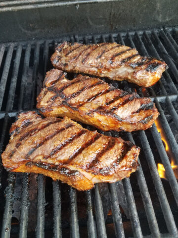 Whiskey marinated steak on a grill