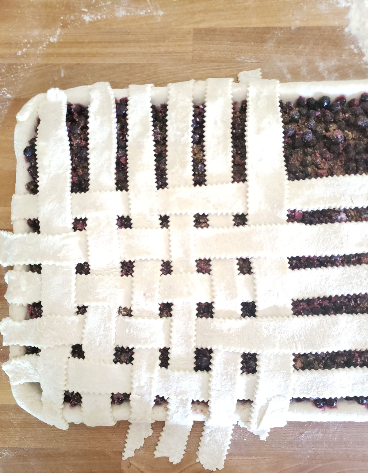 pie on sheet pan weaving lattice crust.