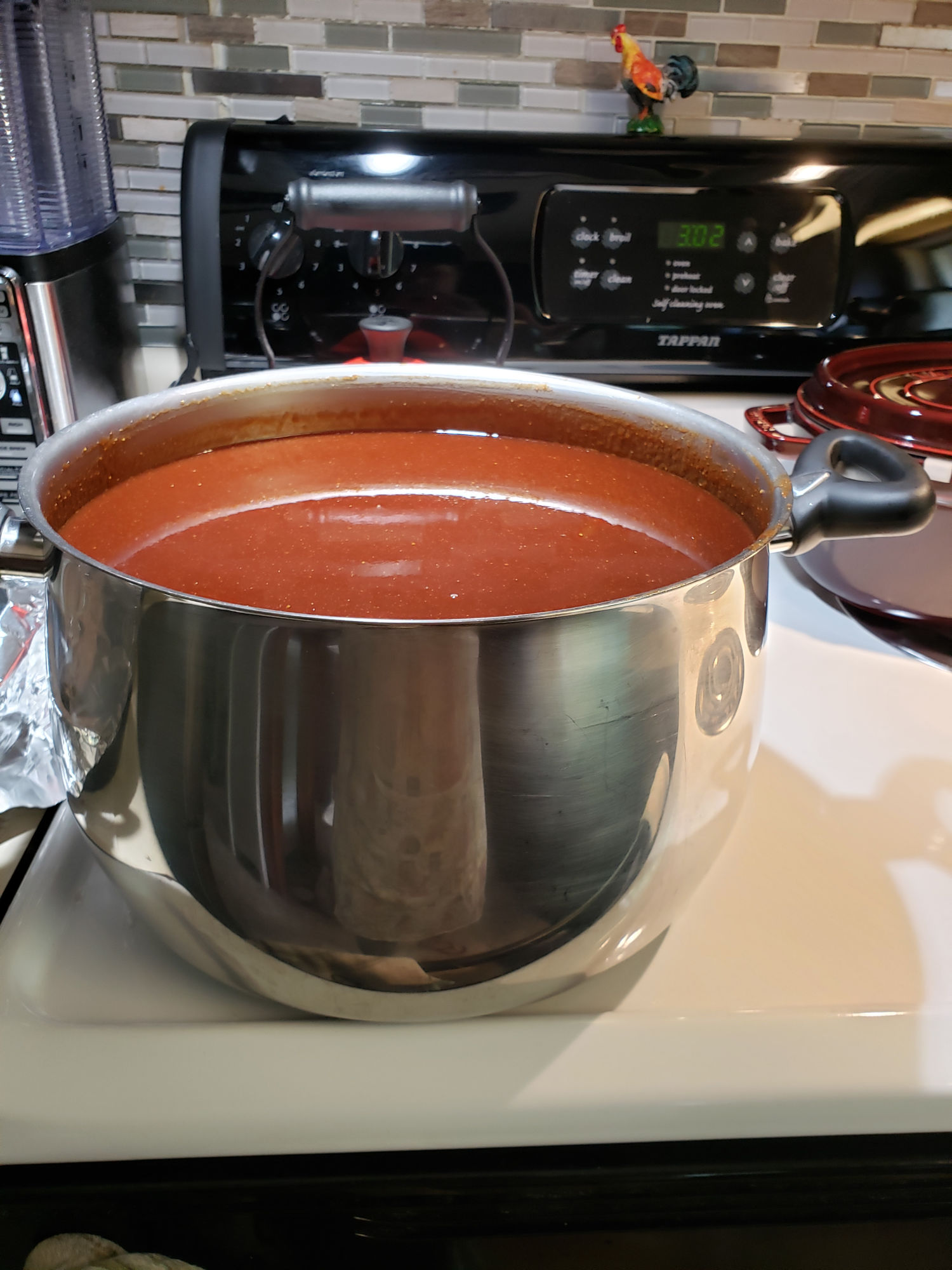 barbecue sauce in a large pot on the stovetop.