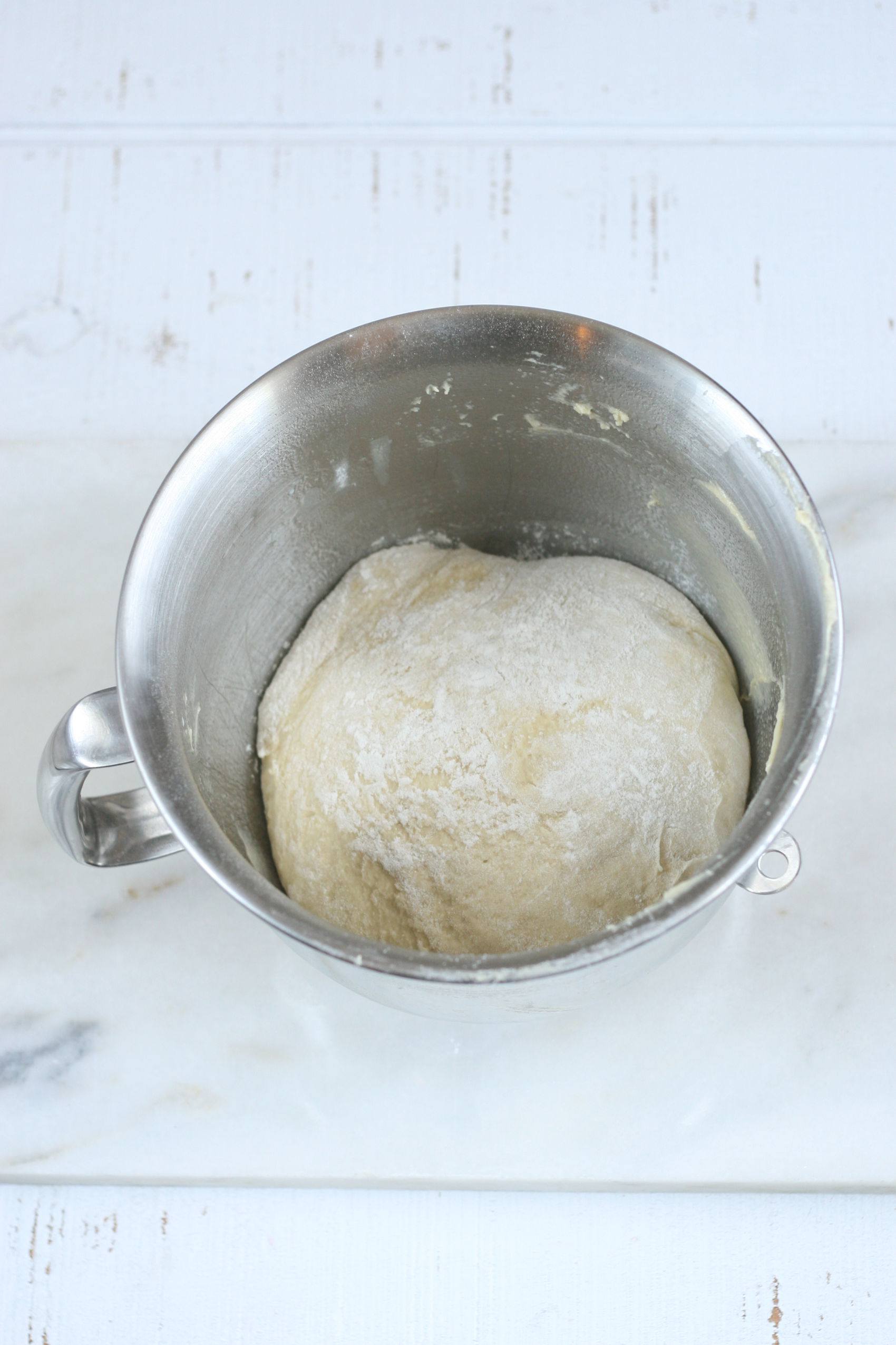 Pizza dough rising in mixing bowl