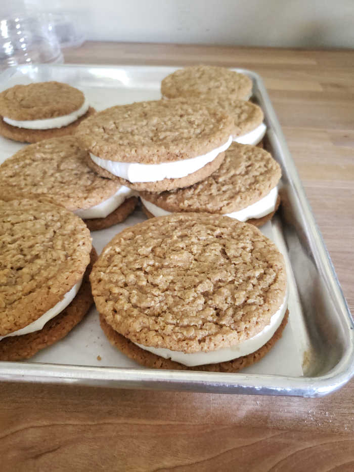 Oatmeal cream cookies on half sheet pan
