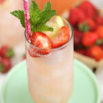 Glass of lemonade with fresh strawberries, lemon and fresh mint.