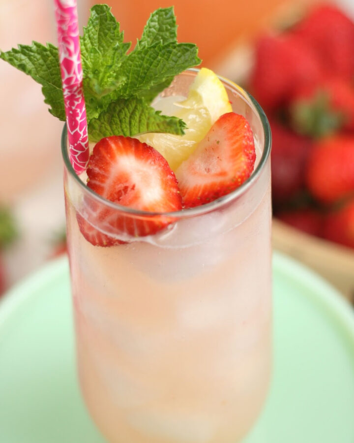 Glass of lemonade with fresh strawberries, lemon and fresh mint.