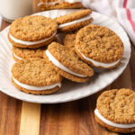 Oatmeal sandwich cookies on white plate.