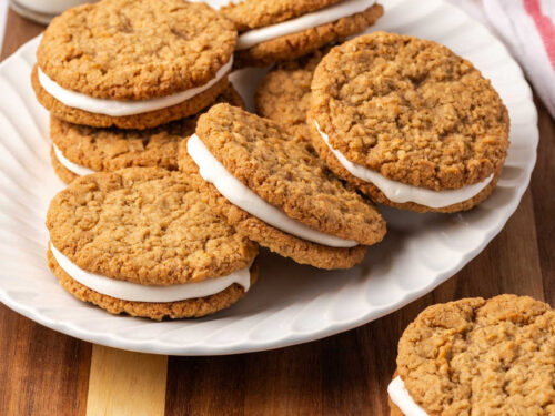 Oatmeal sandwich cookies on white plate.