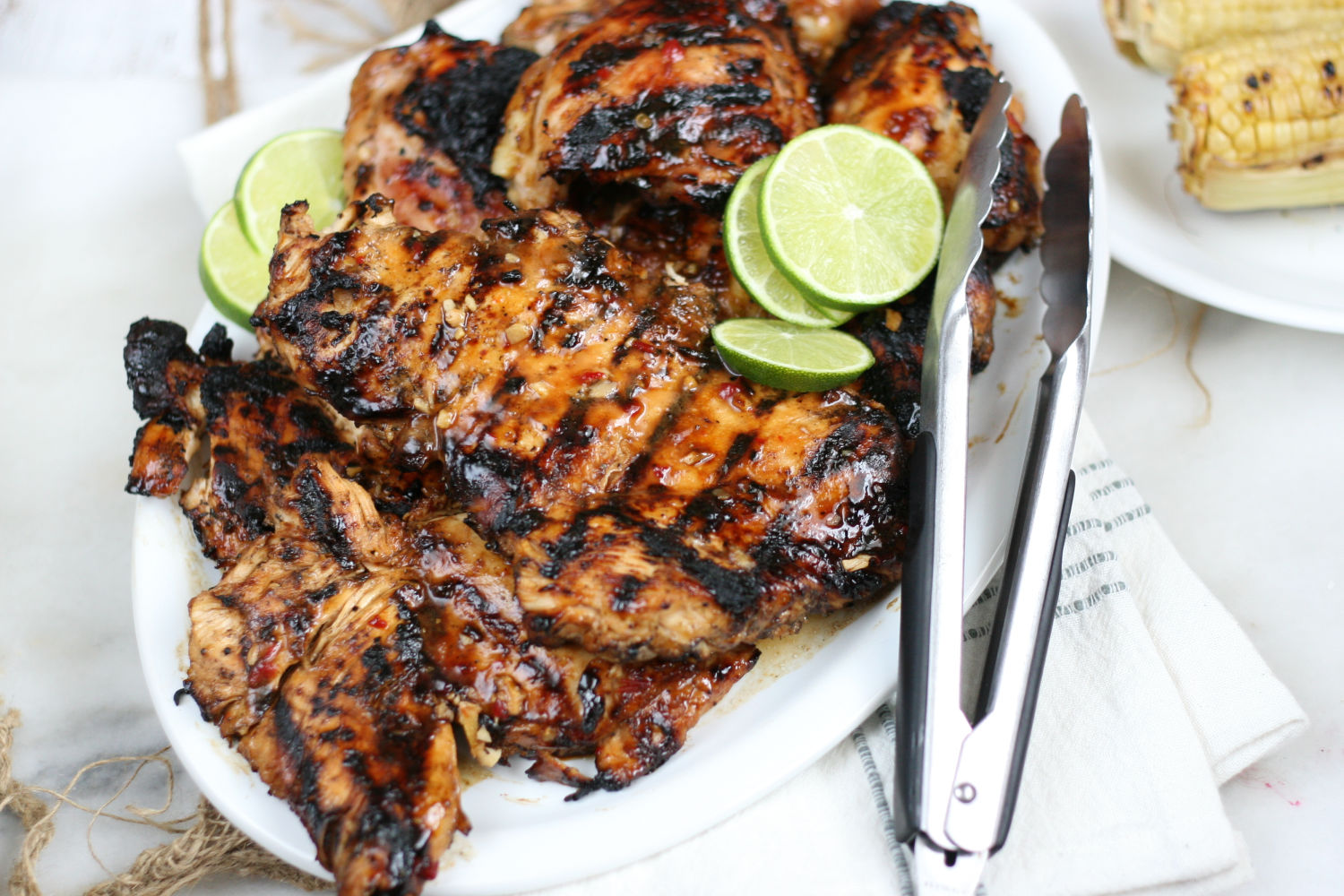 grilled chicken on a white serving plate.