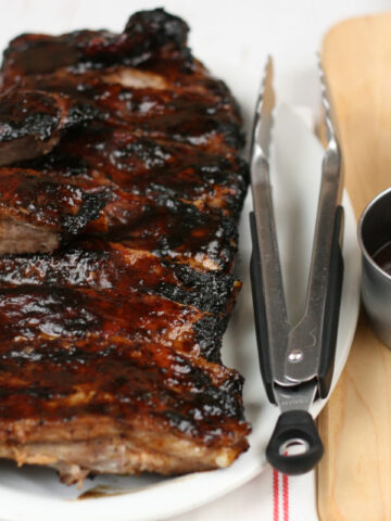 BBQ pork ribs on a white serving plate