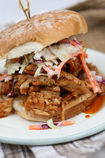 pulled pork on a soft roll topped with coleslaw