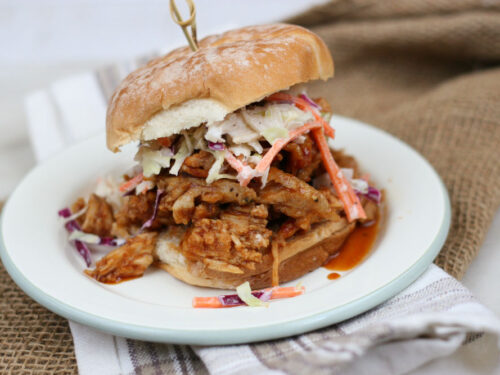 pulled pork on a soft roll topped with coleslaw