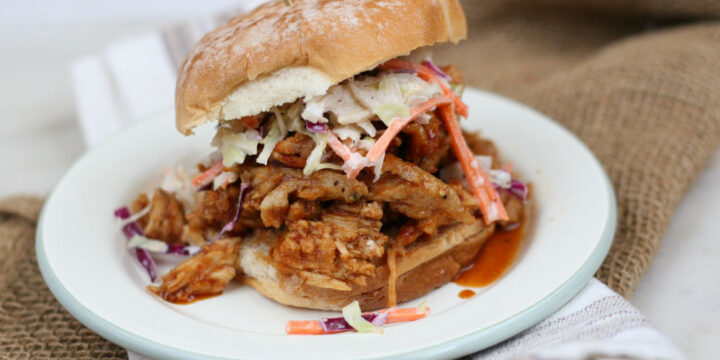 pulled pork on a soft roll topped with coleslaw